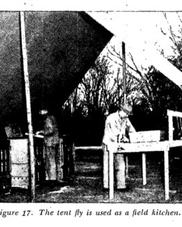 black and white printed photo of a soldier under a canvas awning