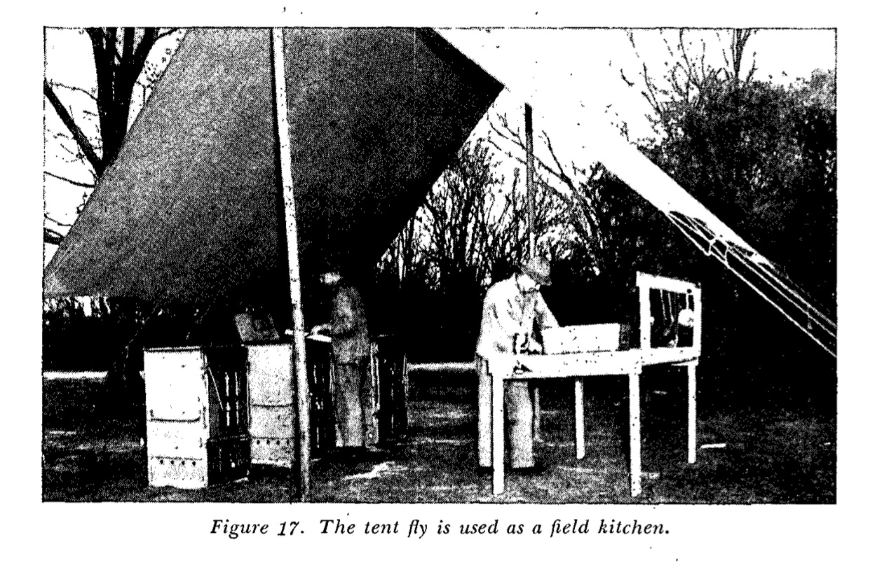black and white printed photo of a soldier under a canvas awning